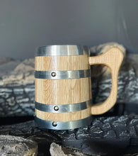 A oak viking beer mug with a natural oak body, hoops, and a handle, 